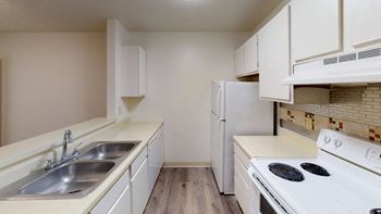 a kitchen with white appliances and white cabinets
